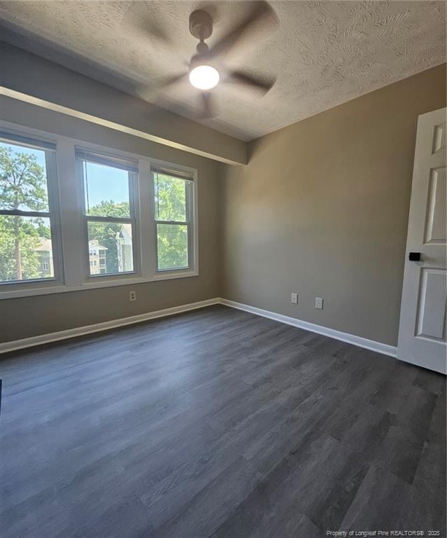6771 Willowbrook Dr Unit 6, Fayetteville, NC 28314 - spare room with healthy amount of natural light, a textured ceiling, dark wood-style floors, and a ceiling fan