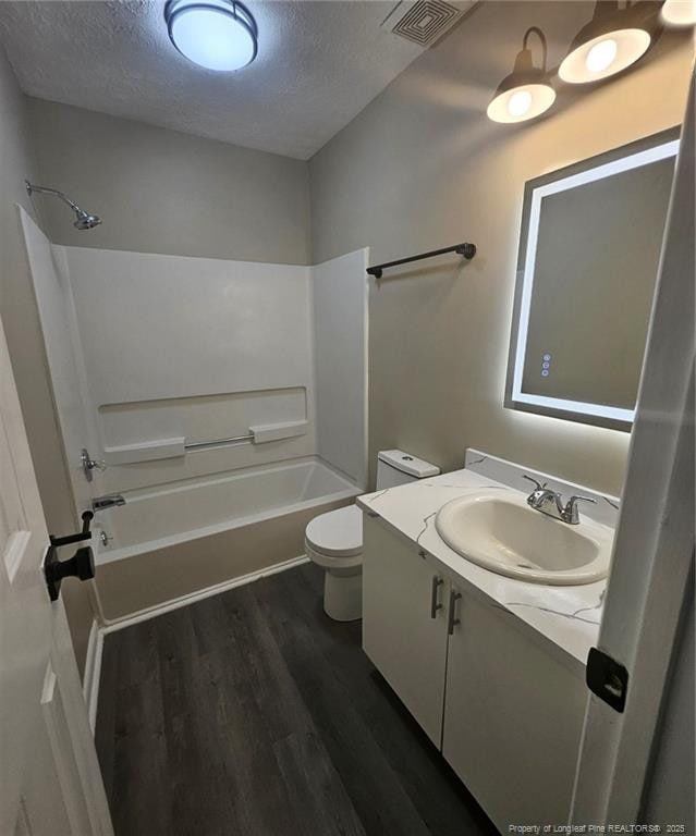 6771 Willowbrook Dr Unit 6, Fayetteville, NC 28314 - full bathroom with wood finished floors, a textured ceiling, vanity, and shower / bathtub combination