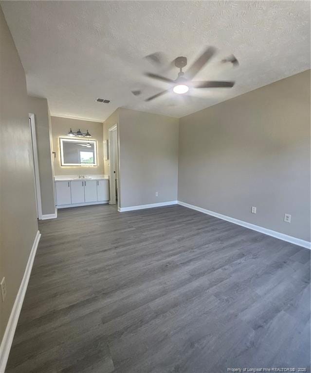 6771 Willowbrook Dr Unit 6, Fayetteville, NC 28314 - unfurnished living room featuring a textured ceiling, a ceiling fan, and dark wood finished floors