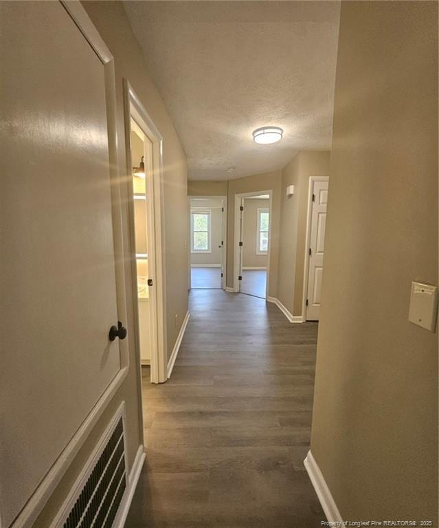 6771 Willowbrook Dr Unit 6, Fayetteville, NC 28314 - corridor featuring dark wood-style floors and a textured ceiling