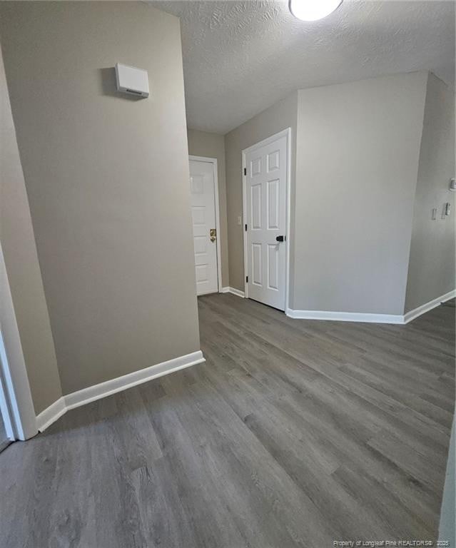 6771 Willowbrook Dr Unit 6, Fayetteville, NC 28314 - spare room featuring wood finished floors and a textured ceiling