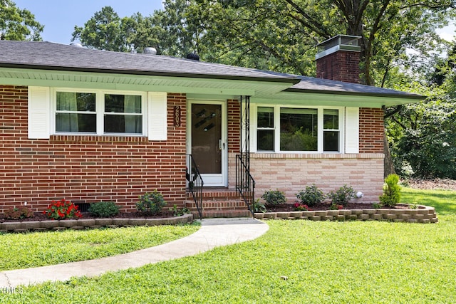 2603 Fairlawn Rd, Durham, NC 27705 - view of front facade featuring brick siding, a front lawn, and a chimney
