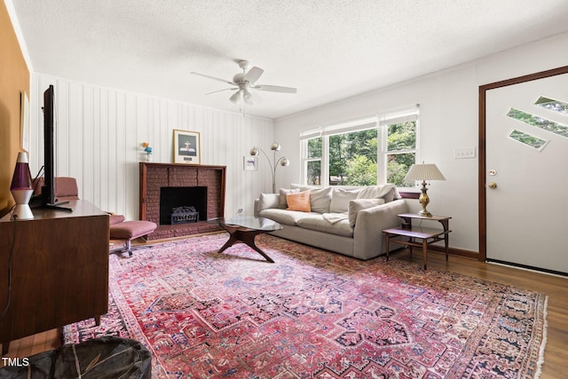 2603 Fairlawn Rd, Durham, NC 27705 - living room with a ceiling fan, wood finished floors, a textured ceiling, and a fireplace