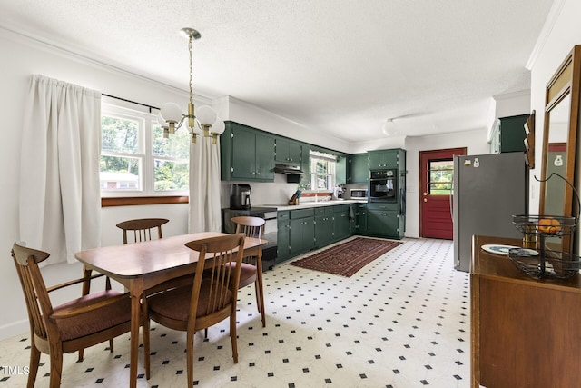 2603 Fairlawn Rd, Durham, NC 27705 - dining area with light floors, a textured ceiling, ornamental molding, and a chandelier