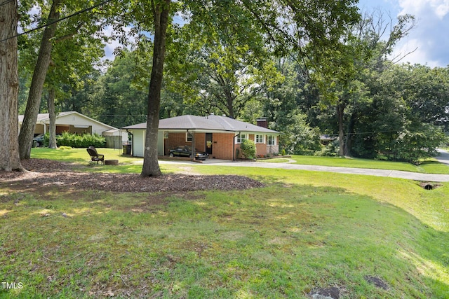 2603 Fairlawn Rd, Durham, NC 27705 - view of green lawn with an attached carport and view of wooded area