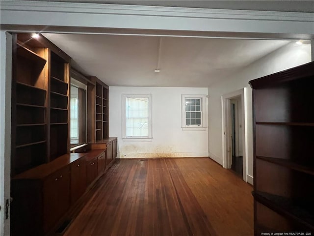 206 E 10th St, Lumberton, NC 28358 - unfurnished living room with dark wood-type flooring and baseboards