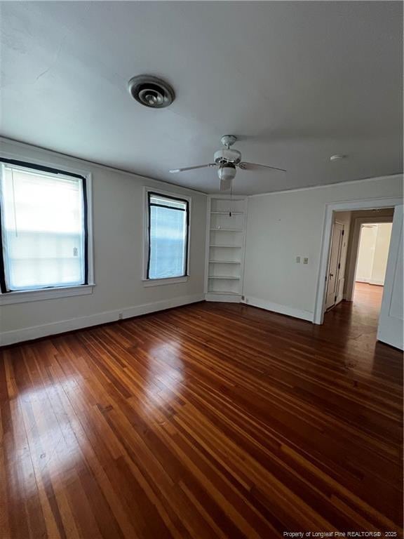 206 E 10th St, Lumberton, NC 28358 - unfurnished room featuring hardwood / wood-style flooring, built in shelves, and a ceiling fan