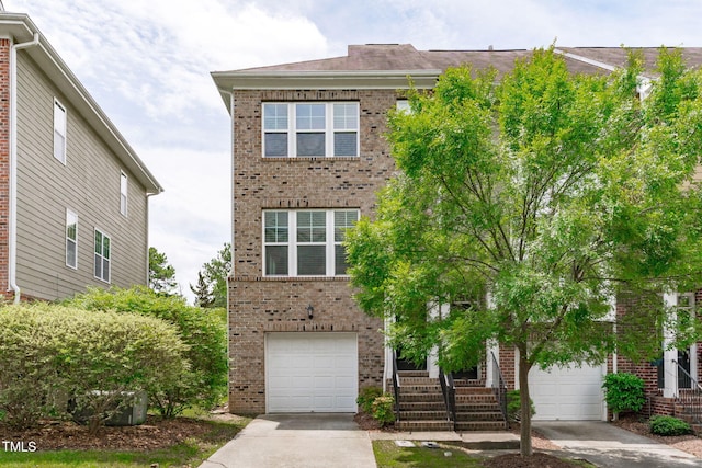 1014 Summerhouse Rd, Cary, NC 27519 - view of front of house featuring brick siding, concrete driveway, and a garage