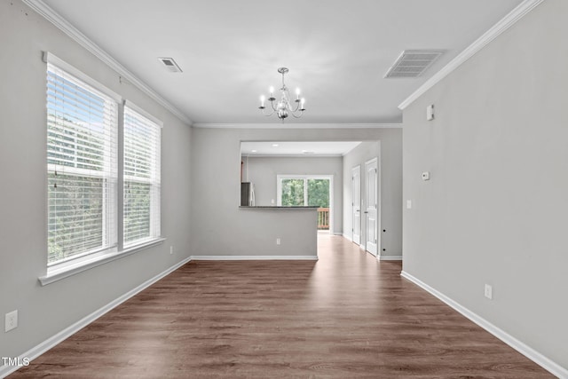 1014 Summerhouse Rd, Cary, NC 27519 - empty room featuring a chandelier, ornamental molding, and wood finished floors