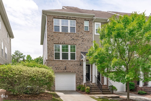 1014 Summerhouse Rd, Cary, NC 27519 - view of front facade featuring brick siding, driveway, and a garage
