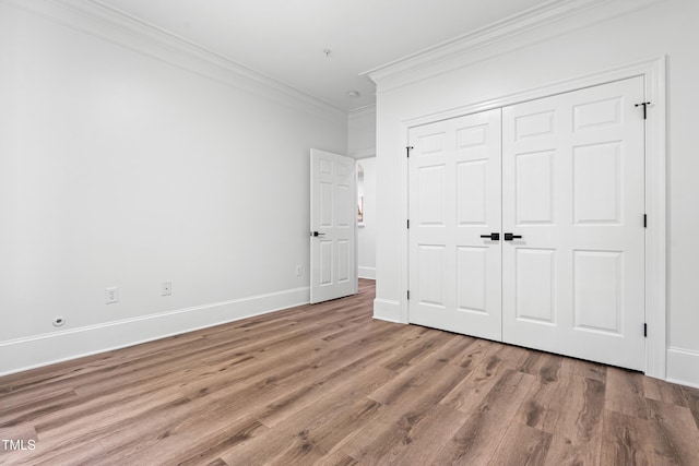 1310 Durlain Dr Unit 102, Raleigh, NC 27614 - unfurnished bedroom with crown molding, wood finished floors, and a closet