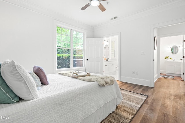 1310 Durlain Dr Unit 102, Raleigh, NC 27614 - bedroom with ornamental molding, ensuite bath, wood finished floors, and ceiling fan