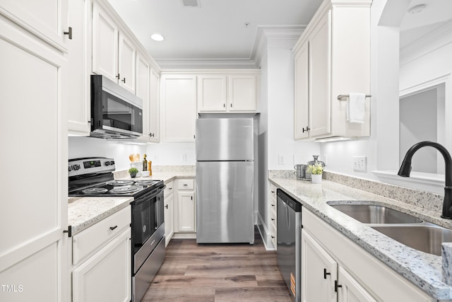 1310 Durlain Dr Unit 102, Raleigh, NC 27614 - kitchen with stainless steel appliances, white cabinets, wood finished floors, ornamental molding, and light stone countertops