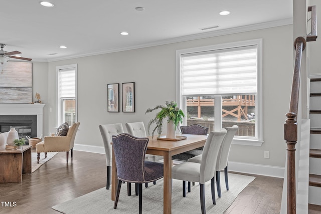 1017 Blackpool Ct, Apex, NC 27502 - dining space featuring wood finished floors, stairway, ornamental molding, recessed lighting, and a ceiling fan