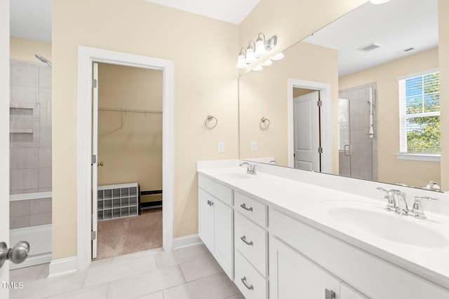 424 Shale Creek Dr, Durham, NC 27703 - bathroom with double vanity, a tile shower, a spacious closet, and tile patterned flooring