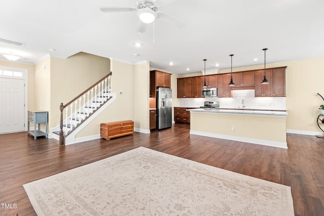 424 Shale Creek Dr, Durham, NC 27703 - kitchen with stainless steel appliances, dark wood finished floors, tasteful backsplash, a center island, and recessed lighting