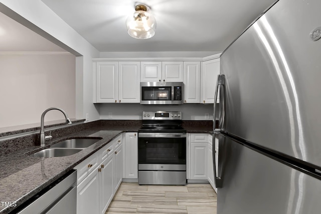 1210 Westview Ln Unit 203, Raleigh, NC 27605 - kitchen with stainless steel appliances, white cabinets, crown molding, and dark stone countertops