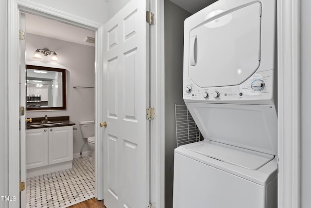 1210 Westview Ln Unit 203, Raleigh, NC 27605 - laundry area featuring stacked washer / dryer and baseboards