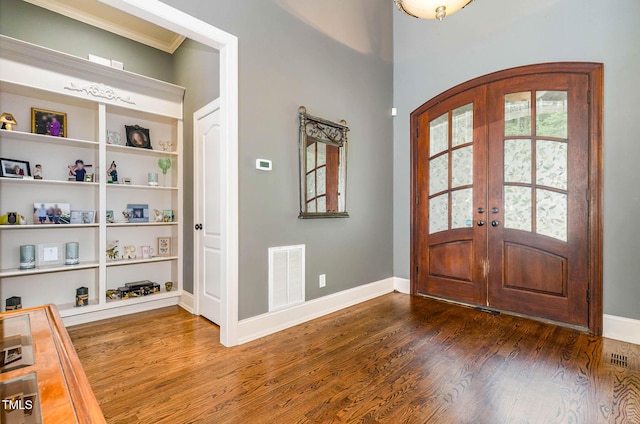 3712 Highland Creek Dr, Apex, NC 27539 - foyer featuring dark wood-type flooring, french doors, arched walkways, and crown molding