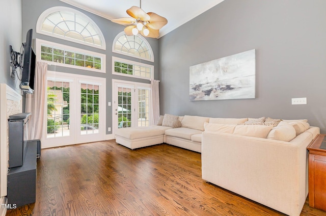 3712 Highland Creek Dr, Apex, NC 27539 - living room with crown molding, wood finished floors, a ceiling fan, and a towering ceiling