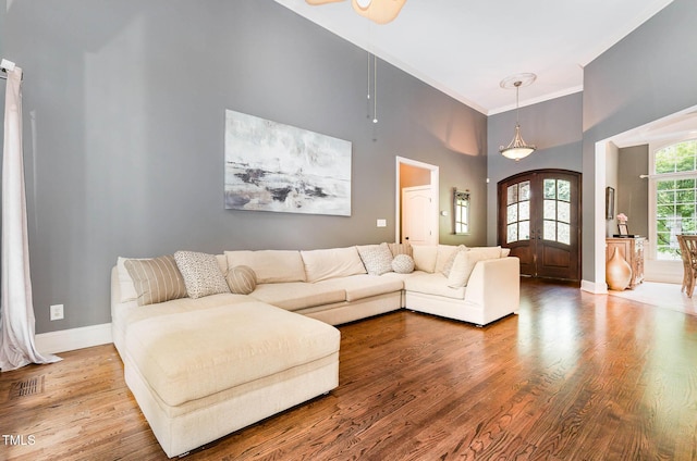 3712 Highland Creek Dr, Apex, NC 27539 - living area featuring ornamental molding, wood finished floors, and a towering ceiling