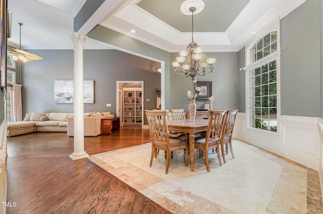 3712 Highland Creek Dr, Apex, NC 27539 - dining space with crown molding, ornate columns, ceiling fan, a chandelier, and wood finished floors
