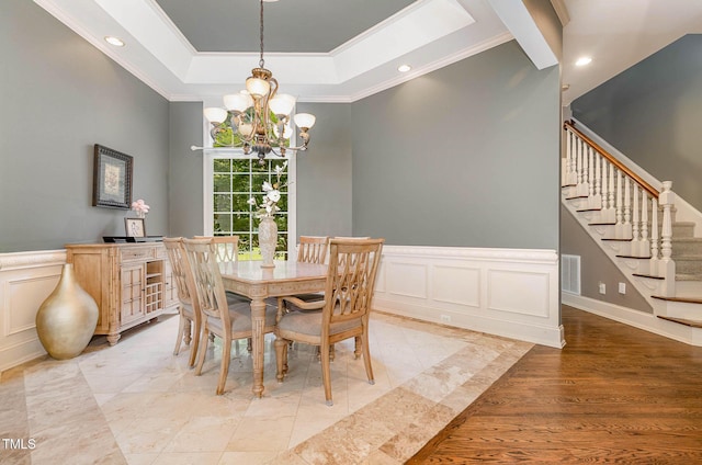3712 Highland Creek Dr, Apex, NC 27539 - dining area with a chandelier, crown molding, a decorative wall, stairs, and a tray ceiling