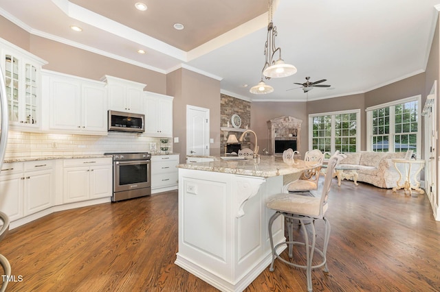 3712 Highland Creek Dr, Apex, NC 27539 - kitchen featuring stainless steel appliances, ceiling fan, open floor plan, dark wood-style flooring, and white cabinets