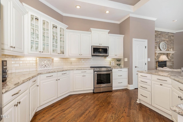 3712 Highland Creek Dr, Apex, NC 27539 - kitchen featuring stainless steel appliances, white cabinetry, dark wood-style flooring, glass insert cabinets, and recessed lighting