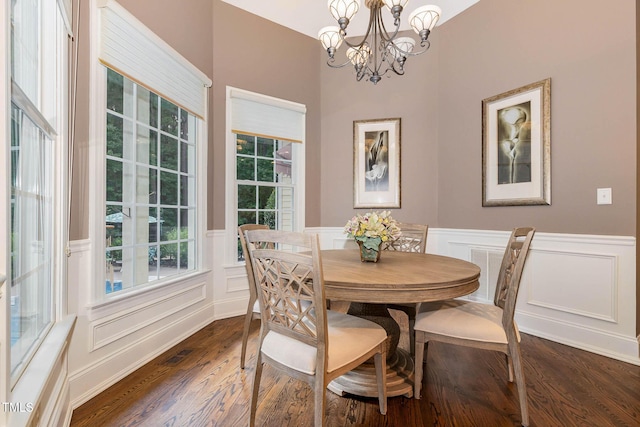 3712 Highland Creek Dr, Apex, NC 27539 - dining area with a chandelier, dark wood finished floors, a decorative wall, and wainscoting