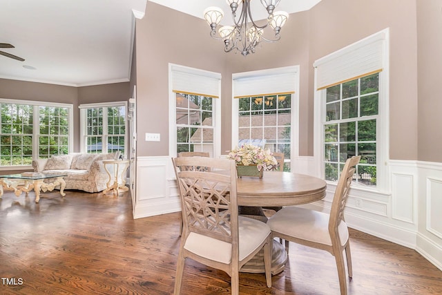 3712 Highland Creek Dr, Apex, NC 27539 - dining area with wainscoting, a chandelier, wood finished floors, a decorative wall, and crown molding