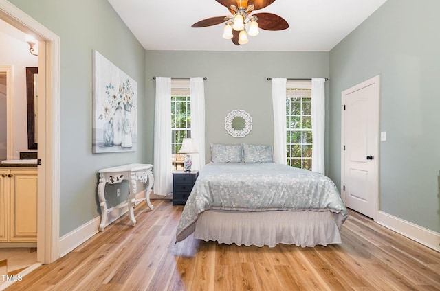 3712 Highland Creek Dr, Apex, NC 27539 - bedroom with multiple windows, light wood finished floors, and connected bathroom