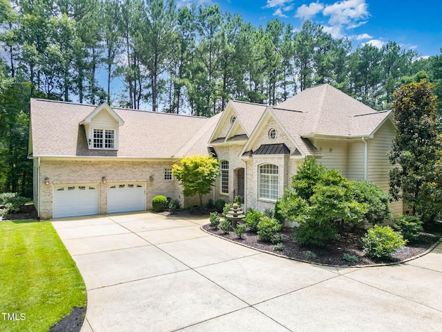 3712 Highland Creek Dr, Apex, NC 27539 - french provincial home featuring concrete driveway, brick siding, and a shingled roof