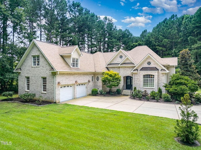 3712 Highland Creek Dr, Apex, NC 27539 - view of front of home with concrete driveway, a front yard, brick siding, a shingled roof, and an attached garage