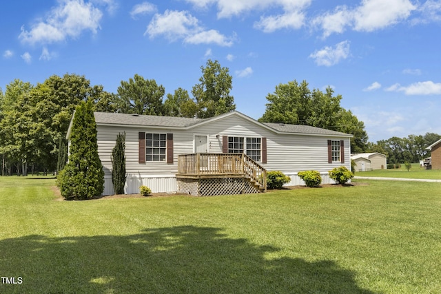 889 Pollock Rd, Kenly, NC 27542 - manufactured / mobile home with a deck, a front yard, and a shingled roof