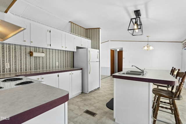 889 Pollock Rd, Kenly, NC 27542 - kitchen featuring freestanding refrigerator, premium range hood, white cabinetry, and light floors