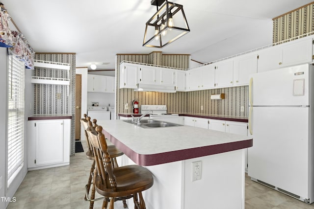 889 Pollock Rd, Kenly, NC 27542 - kitchen featuring white appliances, plenty of natural light, white cabinets, and washer / dryer