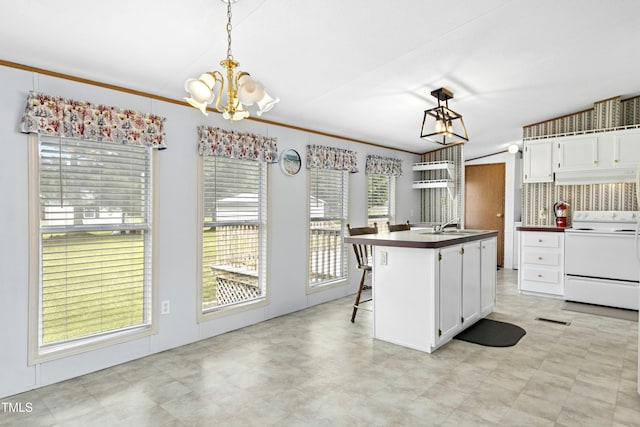 889 Pollock Rd, Kenly, NC 27542 - kitchen with white range with electric cooktop, custom range hood, a chandelier, white cabinetry, and pendant lighting