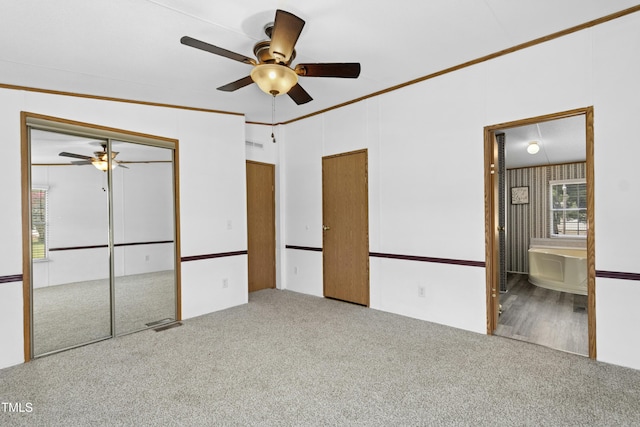 889 Pollock Rd, Kenly, NC 27542 - unfurnished bedroom with carpet flooring, ornamental molding, connected bathroom, a ceiling fan, and a closet