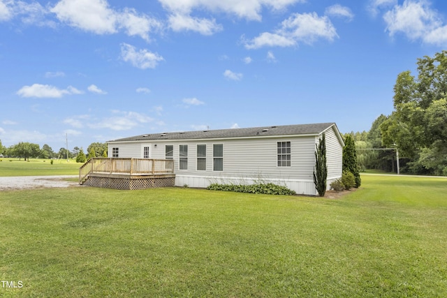 889 Pollock Rd, Kenly, NC 27542 - back of house featuring a wooden deck and a lawn