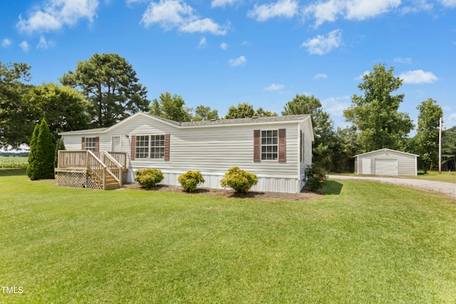 889 Pollock Rd, Kenly, NC 27542 - view of front of property featuring an outbuilding, a detached garage, a front lawn, gravel driveway, and a deck