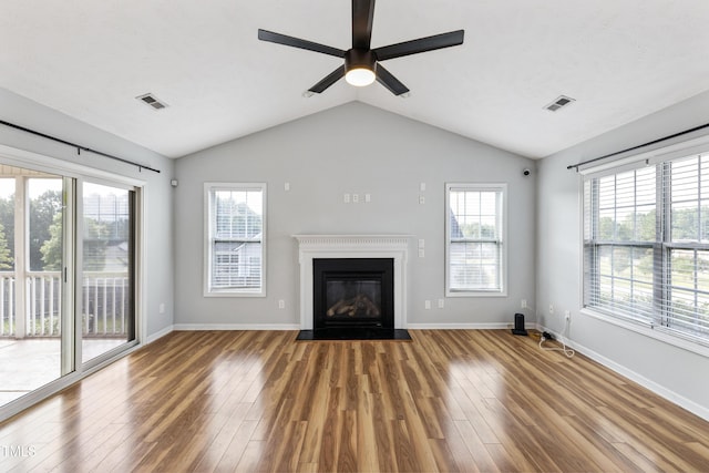 193 Checkmate Ct, Cameron, NC 28326 - unfurnished living room with wood finished floors, a fireplace with flush hearth, ceiling fan, plenty of natural light, and vaulted ceiling