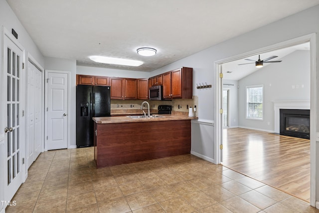 193 Checkmate Ct, Cameron, NC 28326 - kitchen featuring black fridge with ice dispenser, stainless steel microwave, a peninsula, light tile patterned floors, and ceiling fan
