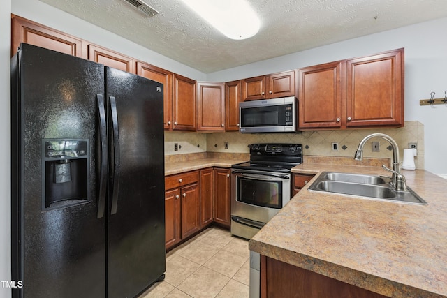 193 Checkmate Ct, Cameron, NC 28326 - kitchen featuring stainless steel appliances, decorative backsplash, brown cabinetry, light countertops, and light tile patterned flooring