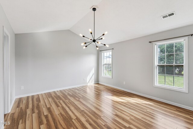 193 Checkmate Ct, Cameron, NC 28326 - spare room featuring plenty of natural light, a chandelier, light wood-style floors, and lofted ceiling