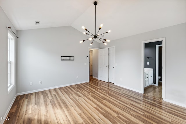 193 Checkmate Ct, Cameron, NC 28326 - unfurnished bedroom with a chandelier, light wood finished floors, and lofted ceiling