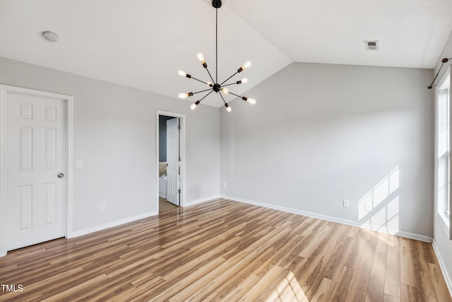 193 Checkmate Ct, Cameron, NC 28326 - unfurnished room featuring a chandelier, a smoke detector, light wood-style floors, and lofted ceiling