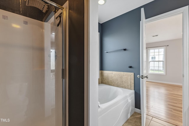 193 Checkmate Ct, Cameron, NC 28326 - bathroom with a bath, a shower stall, and tile patterned floors