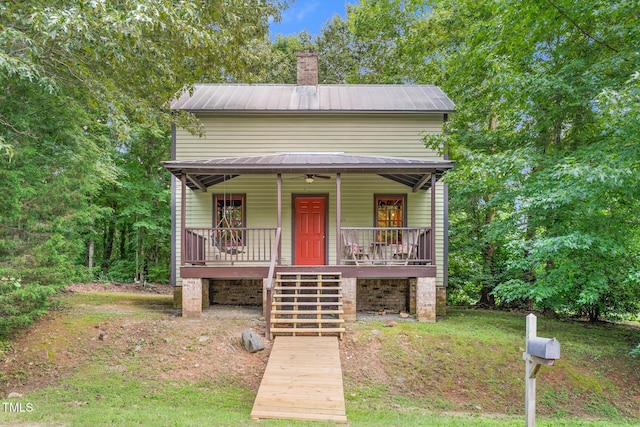 2419 Hodges Rd, Burlington, NC 27217 - view of front of home featuring a porch, stairway, a chimney, and a metal roof