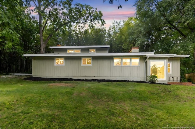 1814 Sunnyside Cir, Fayetteville, NC 28305 - back of house at dusk featuring a lawn